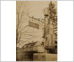 Agnes Fairbairn Beside the Sign for the Original Blue Dragon Inn