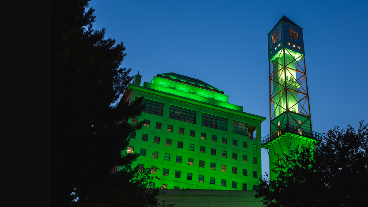 Civic Centre clock tower lit up green.