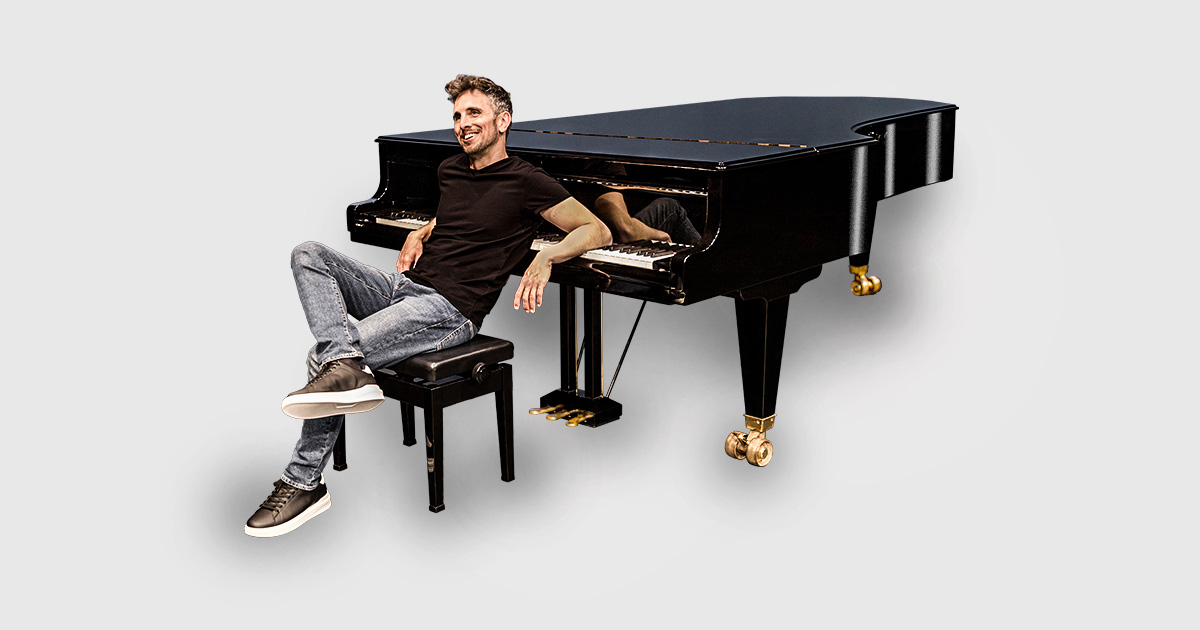 Zade Dirani sitting in front of a piano