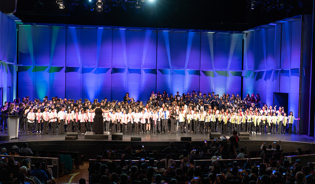 A group of students singing on stage