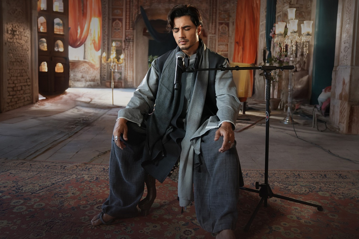 Ali Zafar sitting on a chair