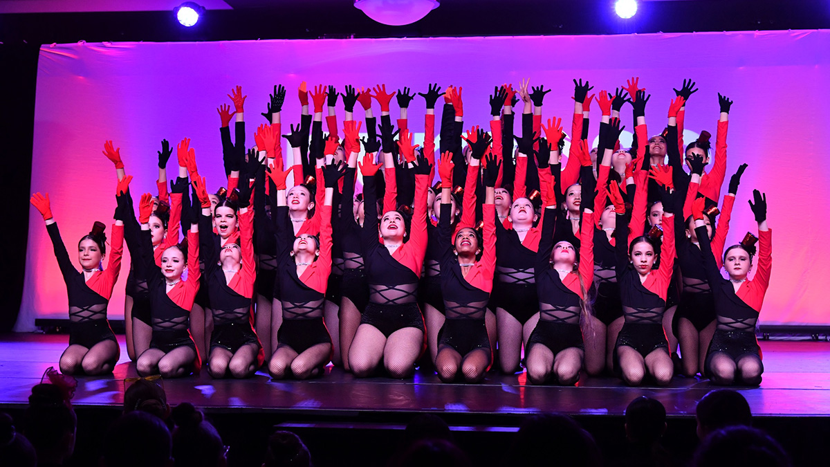 Artistic Edge Dance Company posing on stage