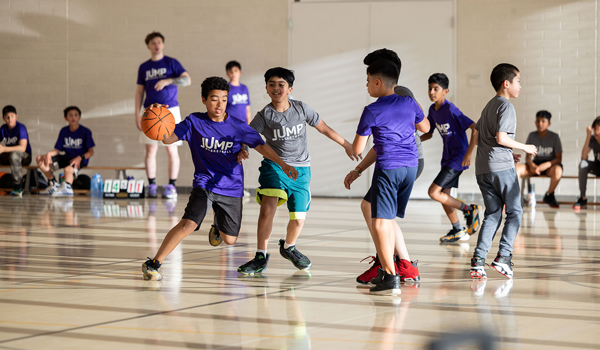Children playing basketball in an indoor gym