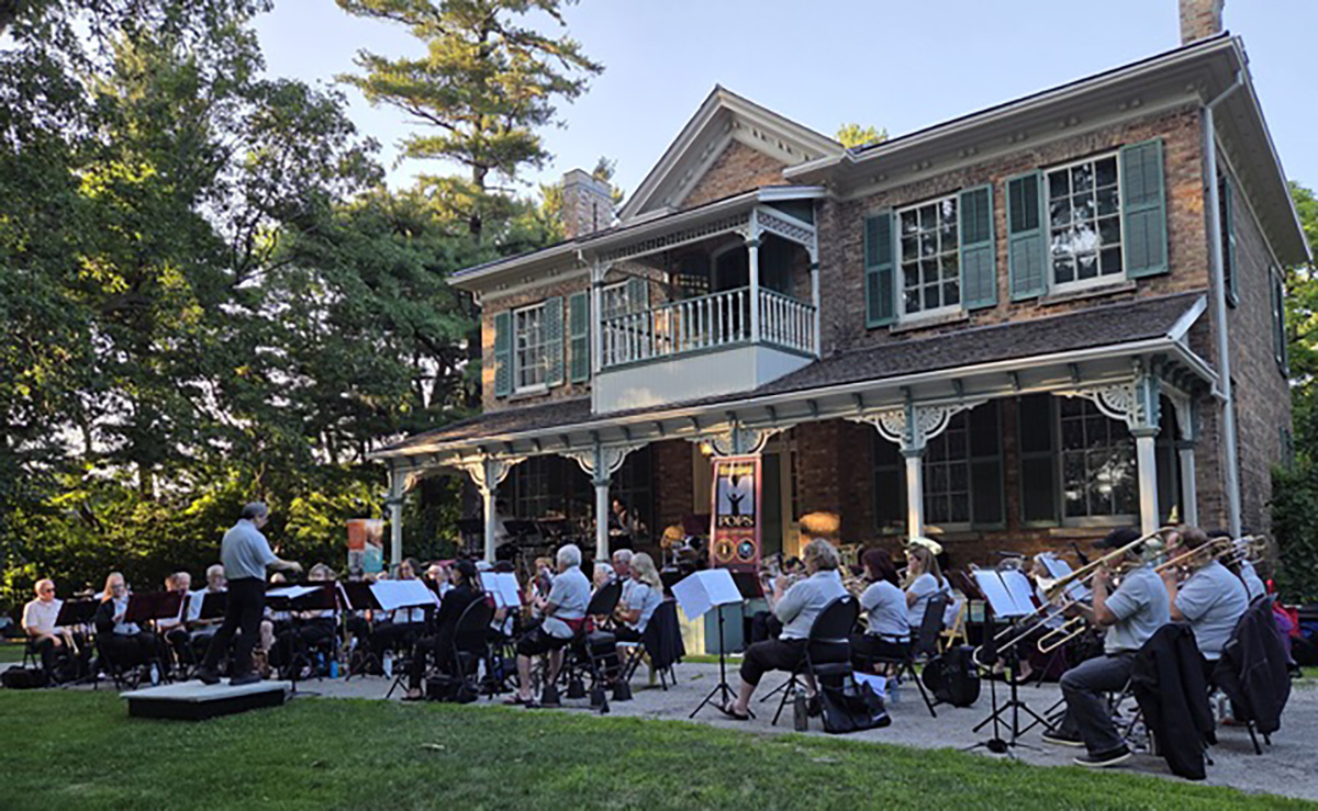 A group of musicians performing in front of Benares Historic House