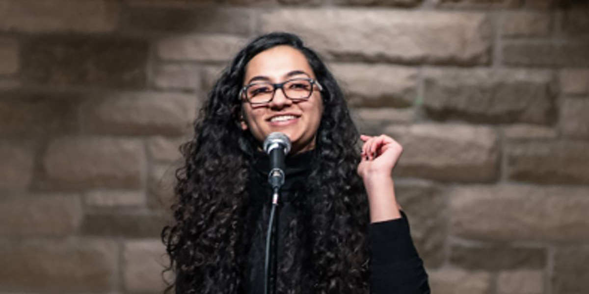 Youth Poet Laureate Qurat Dar performing on stage.