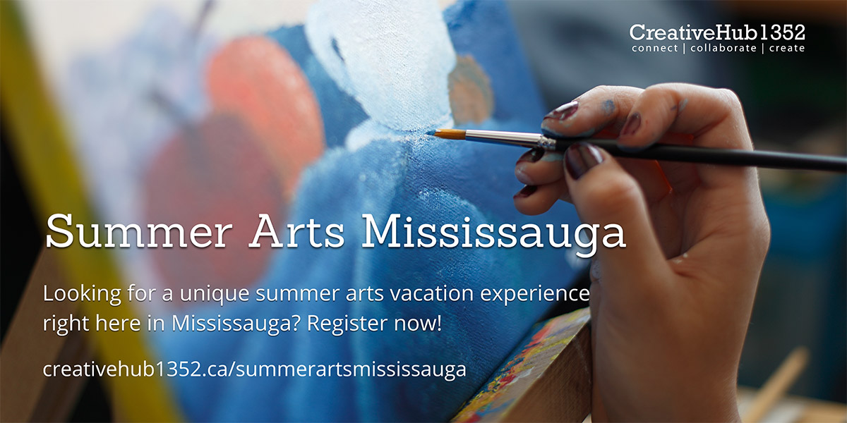 A hand holding a paint brush.