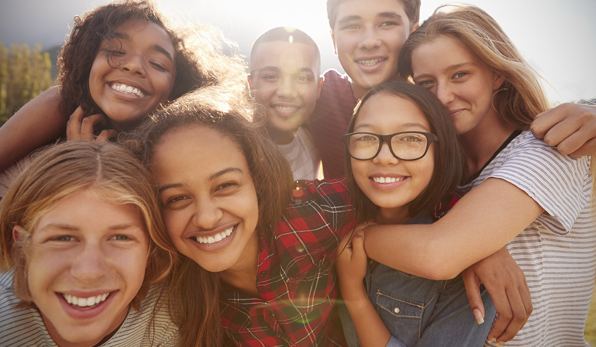 A group of teenagers smiling at the camera.