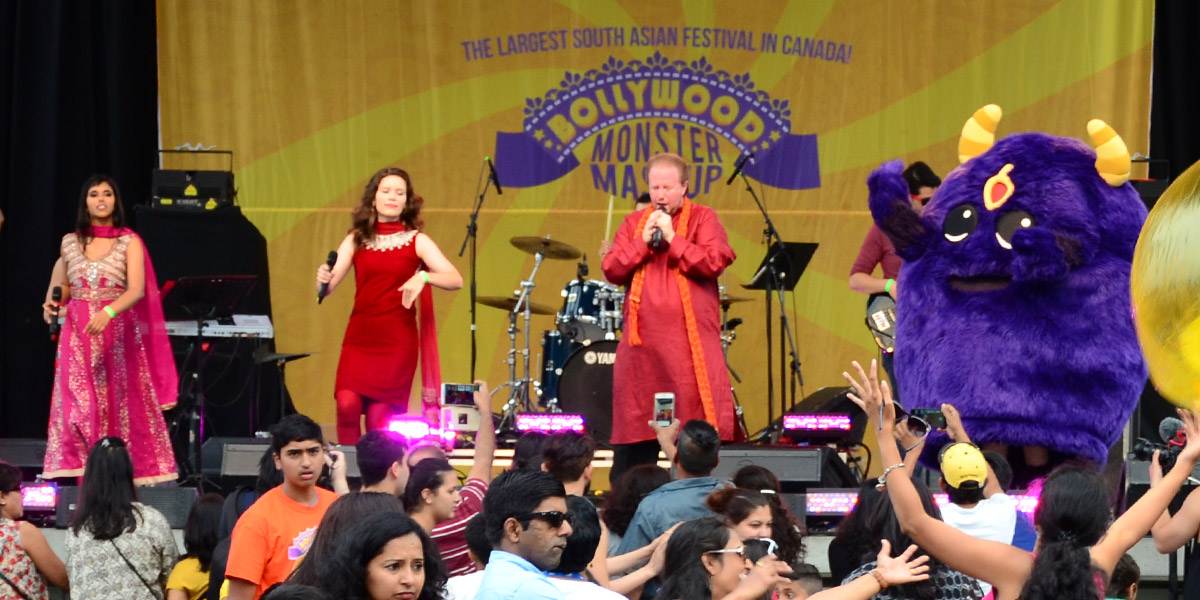 Performers singing on stage at BollywoodMonster Mashup