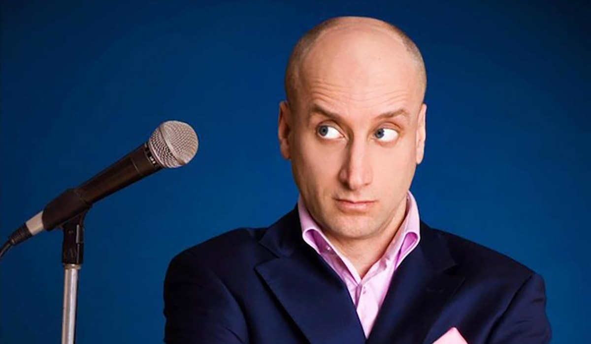 Scott Faulconbridge in front of blue background.