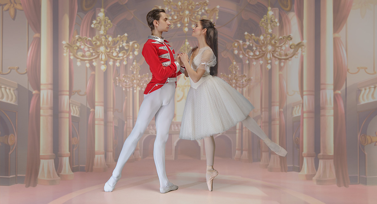A male and female ballet dancer holding a position.