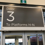 Large sign above door that reads Door 3 To Platforms H-N.