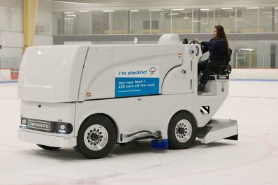 City staff operating an electric ice resurfacer