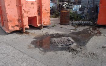 Example of outdoor waste containers that are located too close to the catchbasins on the business’ property and are leaking waste into the catchbasins