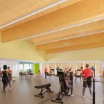 Artist rendering of people stretching, lifting weights and using other fitness equipment in the renovated multi-use fitness studio at Carmen Corbasson Community Centre.