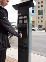 Person using a parking pay machine