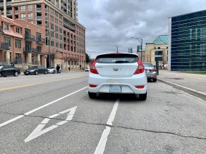 white car parked in bike lane