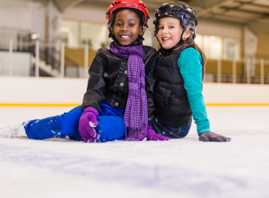 two children sitting on ice