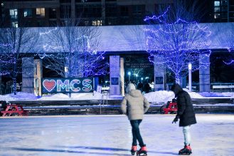 Two people skating at Celebration Square