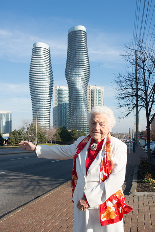 Hazel McCallion, former Mississauga Mayor, gesturing towards the Absolute World residential condominium twin tower skyscrapers.