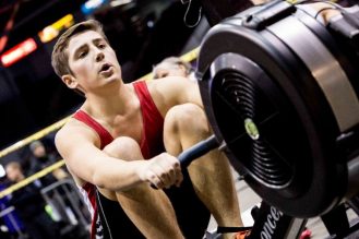 Image of a young adult male rowing in a competition