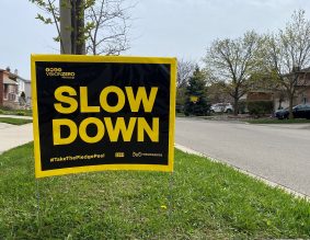 Close up of "Slow Down" signage in neighbourhood street.
