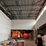 The interior of a partially completed building with an exposed ceiling.
