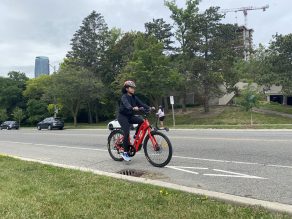 Person riding e-bike in bike lane in Mississauga.