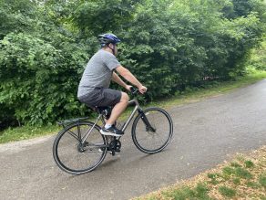 Person riding bike on park trail in Mississauga.