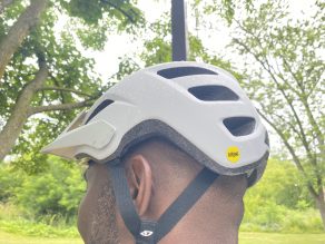 Close up of person wearing white bike helmet.