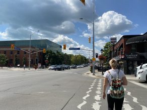 Person walking across crosswalk at a Pedestrian Head Start Signal intersection