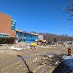 Entrance to Carmen Corbasson Community Centre during construction with equipment and materials nearby.