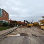 Asphalt is removed in front of Carmen Corbasson Community Centre with construction machinery.