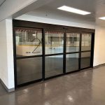 Glass sliding doors with Rink 2 written on them.