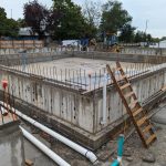 A concrete foundation with rebar sticking up around the perimeter.
