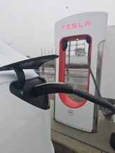 Tesla car charging at a Tesla charging stall