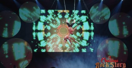 Image shows two performers from A Christmas RockStory performing a trapeze act