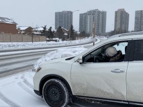 Person driving vehicle in snowy weather in Mississauga.