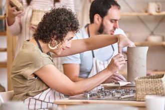 Woman in a ceramics class working on a vase