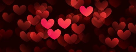 Glowing red hearts against a black background.