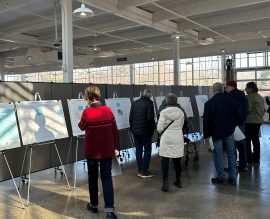 People looking at display boards during an open house meeting