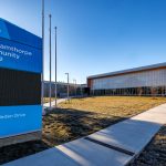 Road sign by the sidewalk at the entrance of the Burnhamthorpe Community Centre