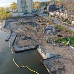 Construction site at Marina Park with piles of rubble and two yellow excavators.