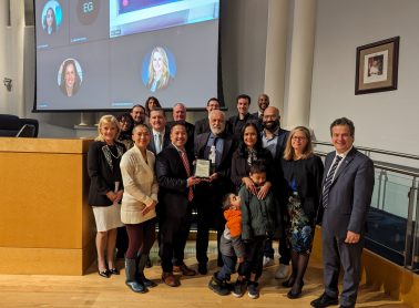 Group of people standing with award recipient