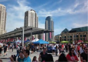 People walking around Mississauga's Celebration Square during a festival