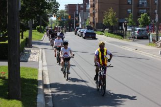 A group of people riding bicycles on a road