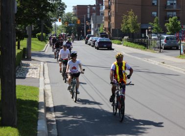 A group of people riding bicycles on a road