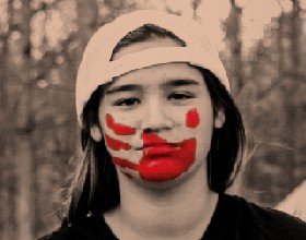 A young person with a red handprint on their face.