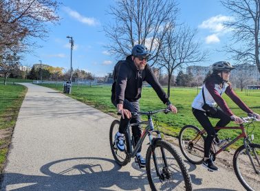Two people biking on a park trail in Mississauga