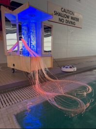 Snoezelen pool machine with sensory items, with a blue and organe colour display