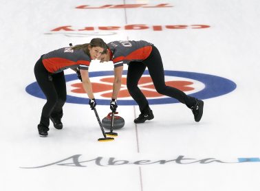 Image of two women curling.